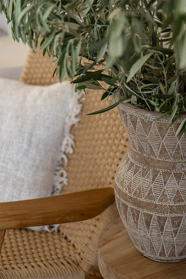 Olive branches in a carved ceramic vase – Studio Blanco interiors