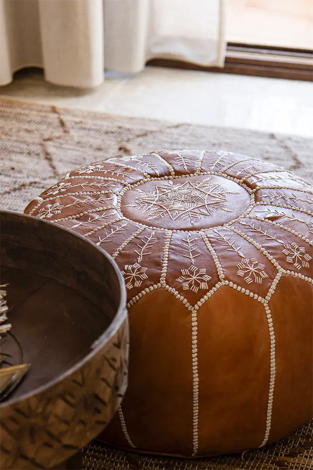 Moroccan leather pouf and brass bowl – Mediterranean interior styling