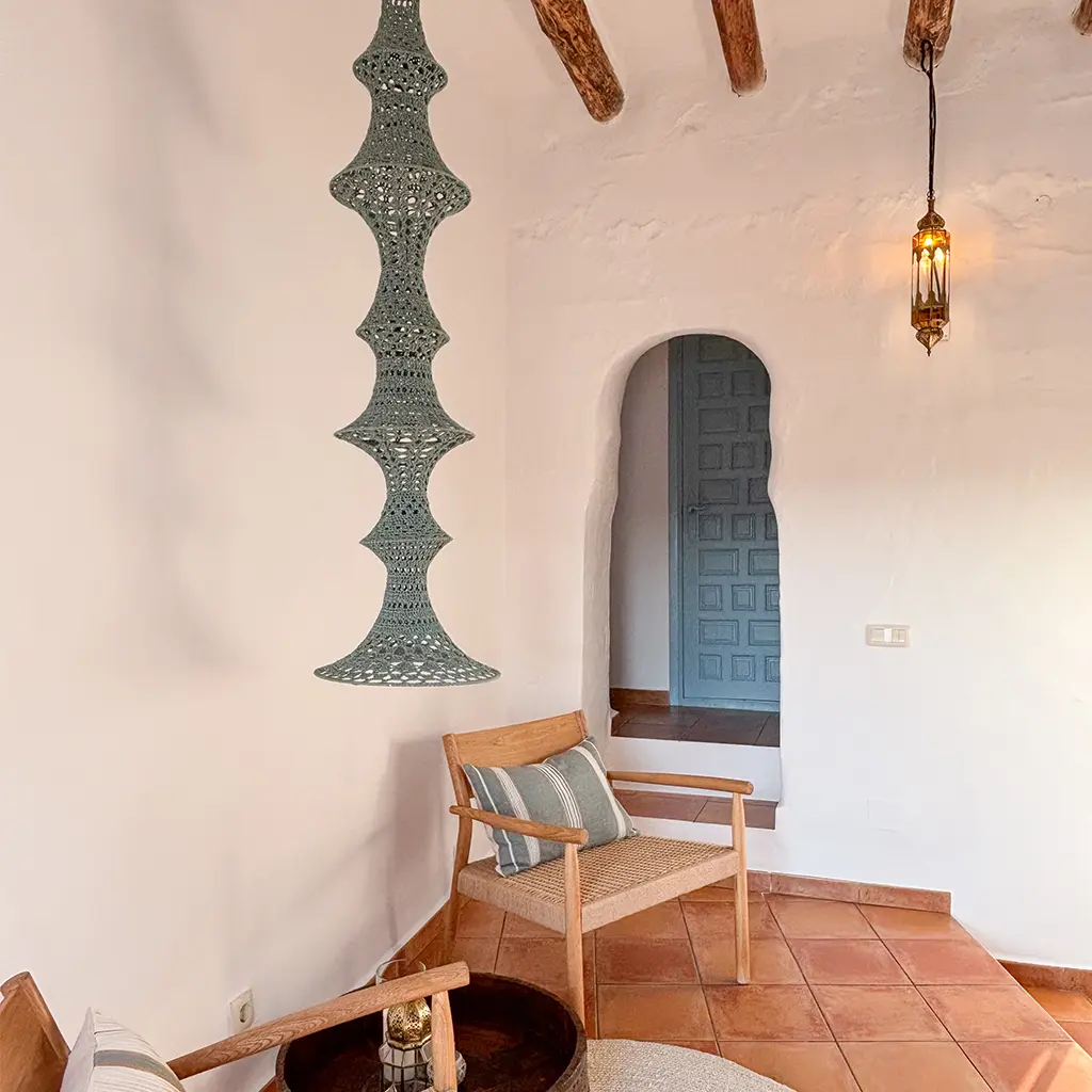 Andalusian interior with arched doorway and hanging lamp – interior design in Frigiliana